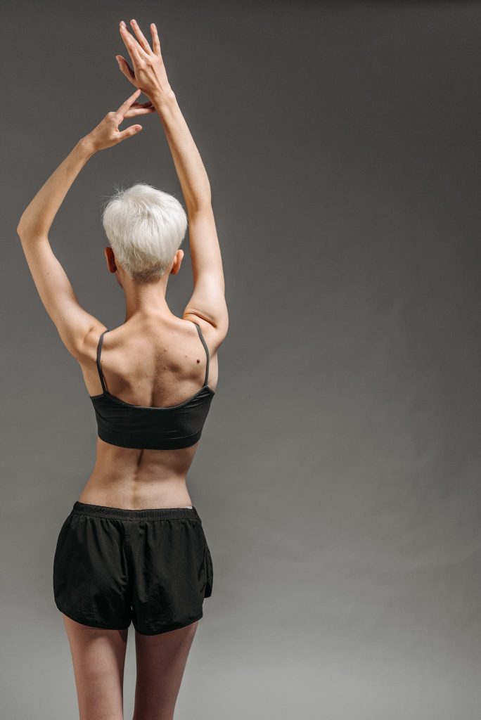 Woman in Black Bra and Black shorts.