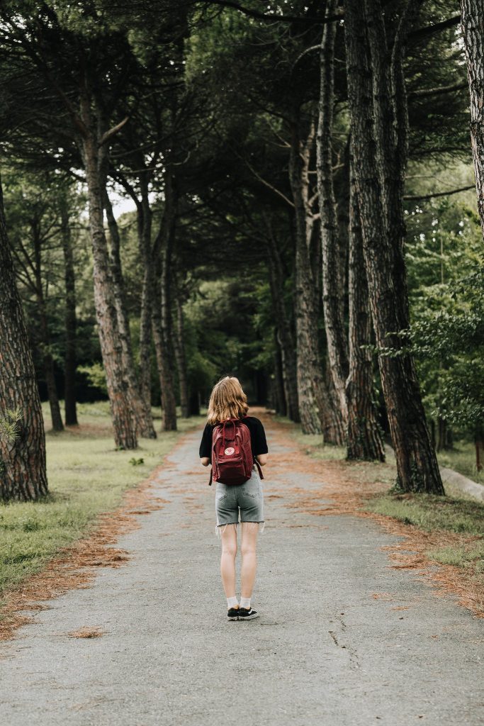 Woman on Footpath in Forest.